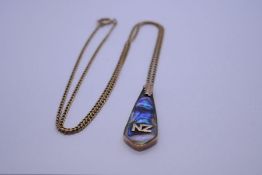 9ct yellow gold neckchain hung with 9ct backed pendant with Mother of Pearl detail and panel NZ' cha