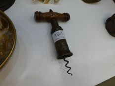 A 19th century, corkscrew having brass barrel, with Royal Coat of Arms plaque