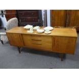 A 1970s nathan teak sideboard, having 3 central drawers with sliding doors and set of 4 dining chair