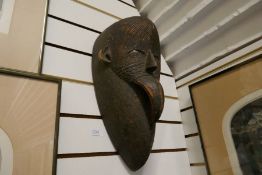 A 20th Century African tribal mask, probably from the Congo, length 45cm