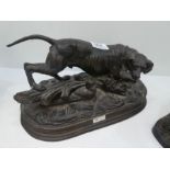 A reproduction bronze figure of dog on oval base and one other cast iron dog sculpture