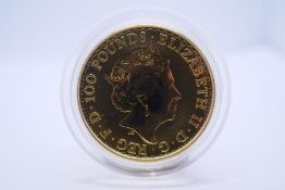 A 2017 Britannia 1 oz 100 pound gold coin, in capsule