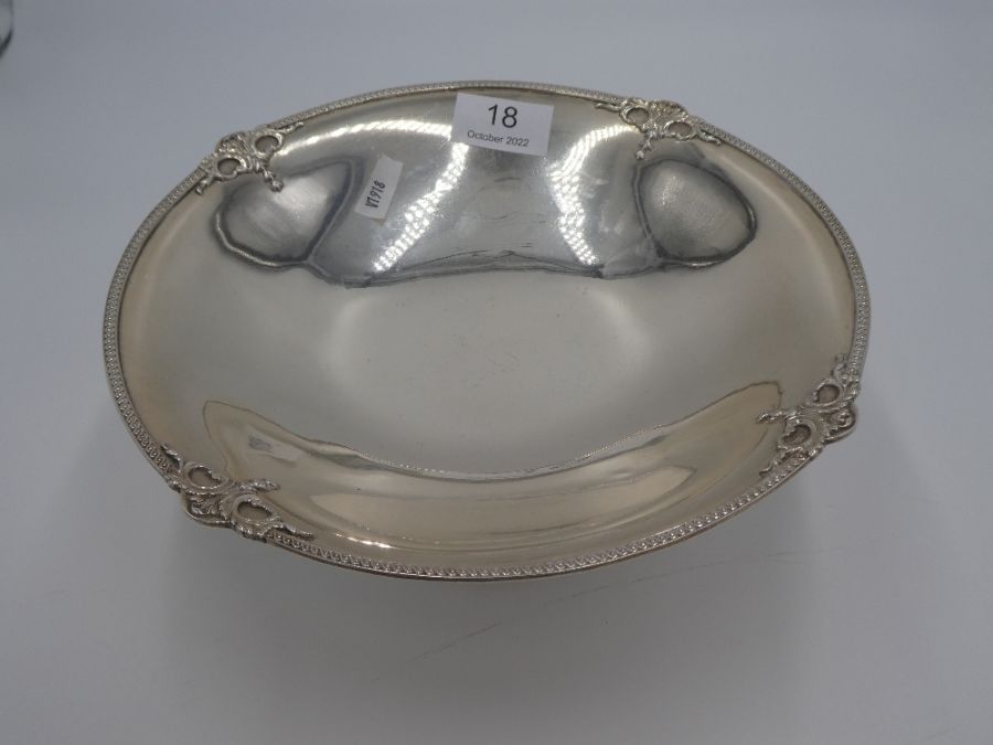 A silver fruit bowl on a raised pedestal foot having embossed border, hallmarked London 1930, Blackm