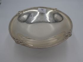 A silver fruit bowl on a raised pedestal foot having embossed border, hallmarked London 1930, Blackm