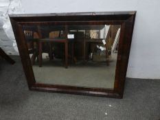 An antique oblong mirror having Yew wood cushion style frame, 75cm