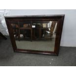 An antique oblong mirror having Yew wood cushion style frame, 75cm