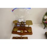 A set of Postage scales, brass weights and a few commemorative coins