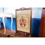 A mahogany firescreen with needlework panel of cre