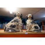 A pair of large size porcelain figures, Staffordshire in style, depicting Spaniels