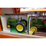 Four die cast metal models of John Deere tractors including collector's editions, manufactured by "E