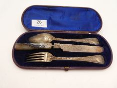 A cased Victorian silver flatware comprising of a spoon, fork and silver blade knife AF. Decorative