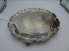 A very large, heavy silver tray with ornate, engraved design, decorative raised border and three scr