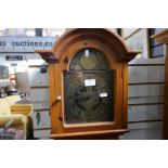 A reproduction Yew Wood long case clock, having weights and pendulum