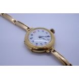 Antique 18ct yellow gold cased circular watch with enamelled dial, on 15ct yellow gold strap, marked