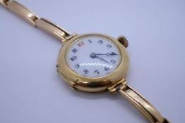 Antique 18ct yellow gold cased circular watch with enamelled dial, on 15ct yellow gold strap, marked
