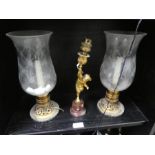 A gilt metal Cherub candlestick on marble base and a pair of Hurricane lamps
