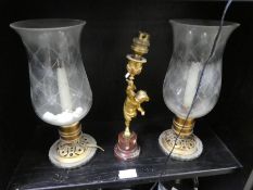 A gilt metal Cherub candlestick on marble base and a pair of Hurricane lamps