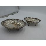 A pair of silver pierced border trinket dishes on four feet, having petal design rim. Hallmarked Bir