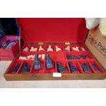 A chess set, cased, pieces and a box of vintage dolls and teddies