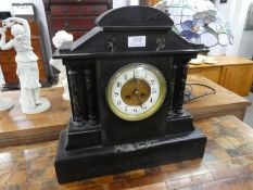 A large Victorian slate mantle clock having marble columns