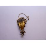 Antique yellow metal brooch with central pear shaped Citrine framed with a scrolling yellow metal mo