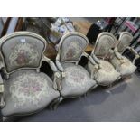 A set of 4 cream painted and gilt decorated French open armchairs having tapestry style upholstery