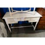 A white painted dressing table with easel mirror and similar bedside chest