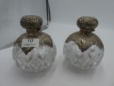 A pair of Edwardian silver surmounted by a silver panel with carved detail and decorative cut glass