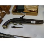 An early 19th Century Flintlock pistol having brass decoration, AF