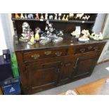 A late 18th century oak dresser base with associated rack back, 141cms