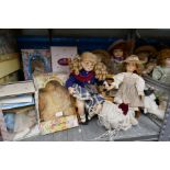 A large selection of modern porcelain dolls, some still boxed and a vintage mantle clock