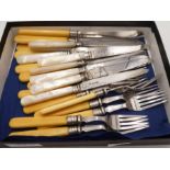 A quantity of flatware to include Mother of Pearl handled silver engraved fruit knives with ornate d