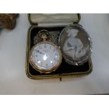 A small gold plated pocket watch by GWC company and a cameo brooch with silver mount