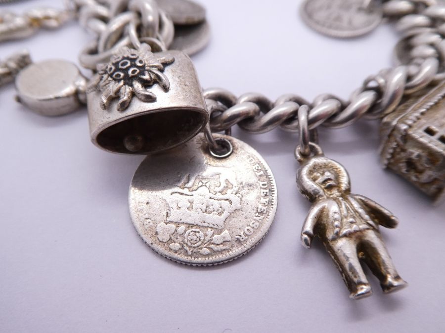 Silver charm bracelet hung with antique and later coins, charms etc including Fireman's helmet, ball - Bild 2 aus 5