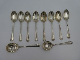 A set of eight silver dessert spoons having rat tail design. Hallmarked Sheffield 1934 Walker and Ha