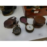 An antique pocket Aneroid Barometer, in fitted case and two military pocket compasses, one dated 191