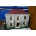 An old Tri-ang dolls house with a tray of furniture