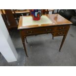 A small Edwardian inlaid mahogany writing table with letter and stationery compartment