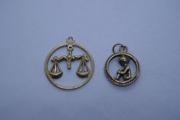Two 9ct yellow gold charms, one with seated Pixie, the other depicting scales, both marked, weight a