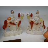 A pair of 19th century Staffordshire Spaniels, with seated figures holding basket of flowers, height