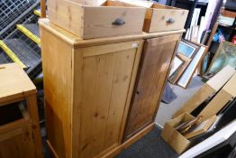 A stripped pine two door kitchen cupboard