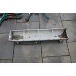 A galvanised pig feeding trough