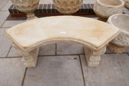 A modern garden bench with curved seat