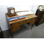 An Arts and Crafts oak desk having four drawers, (the top drawers stamped with registered number), 1