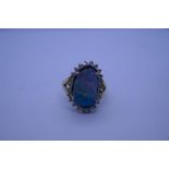 18ct ladies cluster ring with large boulder opal surrounded by glass stones on 18ct splilt shoulder