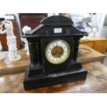 A large Victorian slate mantle clock having marble columns