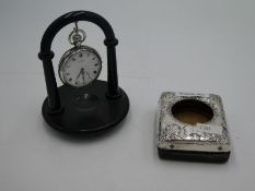 A silver Half Hunter pocket watch on a stand, the enamel dial marked J.W. Benson London, having Roma