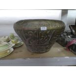 A large Eastern brass pot decorated animals and Islamic writing, 53cms diameter