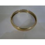 A 9ct yellow gold circular bangle 7cm diameter, marked 375 and 10.3g approx