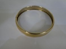 A 9ct yellow gold circular bangle 7cm diameter, marked 375 and 10.3g approx